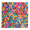 A close-up of colorful soft polymer clay candy sprinkles scattered across a surface.