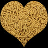 A heart shape filled with light yellow cylindrical polymer clay candy sprinkles for cake decorating