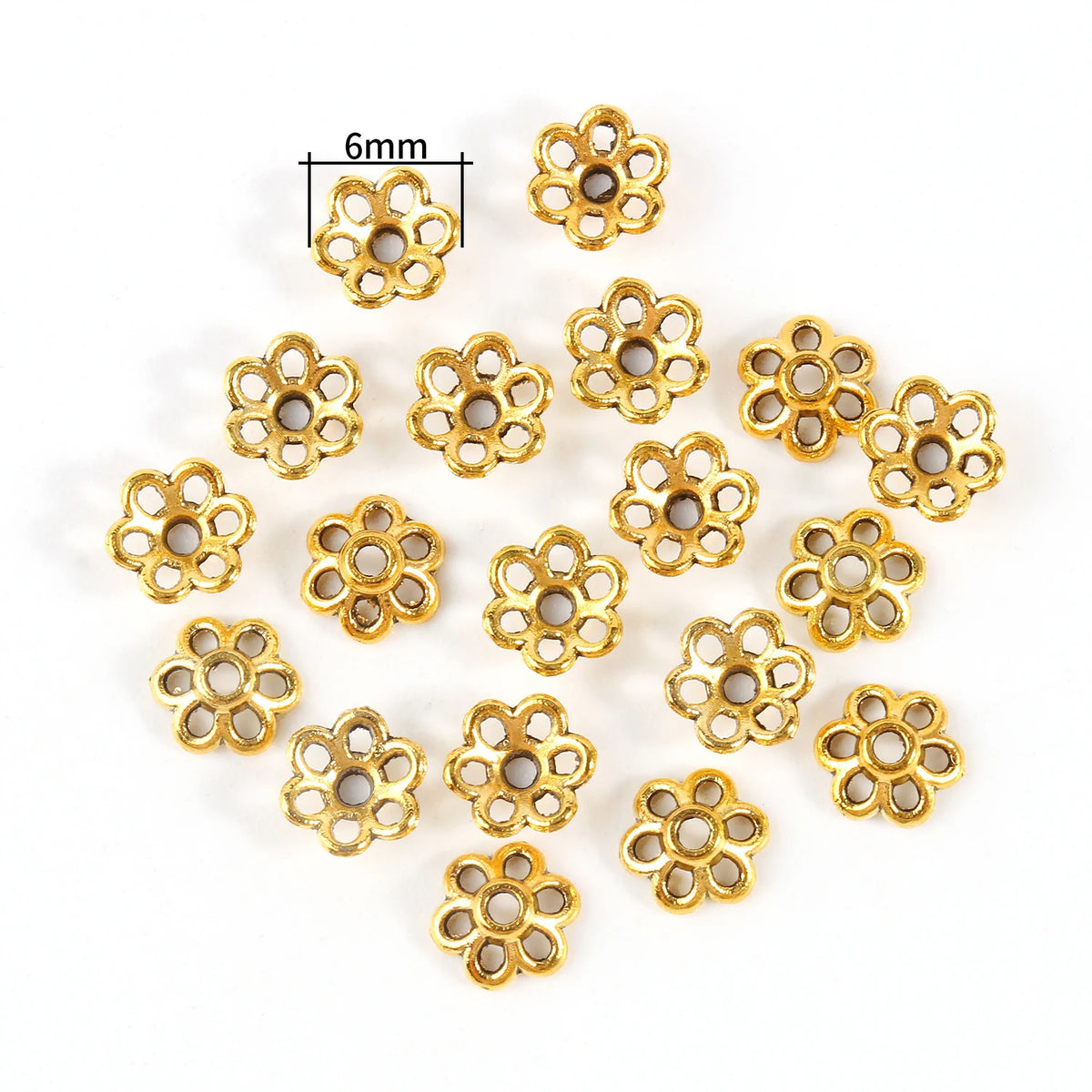 A collection of small, gold-colored Tibetan style hollow flower bead caps for jewelry making.