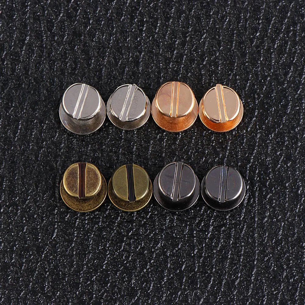 A row of eight decorative heart brass rivets for leather craft and DIY projects.