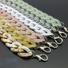 A row of acrylic bag chain straps in various pastel colors, including white, pink, and yellow, with metal clips.