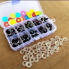 A clear plastic box filled with colorful plastic safety eyes for dolls and amigurumi, alongside loose white plastic eye parts