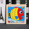 A wooden tangram puzzle featuring a colorful fish design with yellow, red, and blue elements.