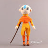 A plush toy set featuring a monkey character with blue markings and an orange outfit, holding a stick.