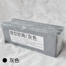 A rectangular block of gray professional soft polymer clay for sculpting and doll making