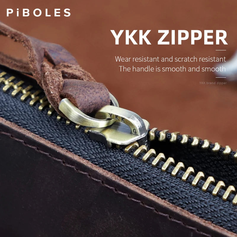 Close-up of a brown leather coin purse showing a brass zipper pull and a suede leather strap.