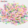 A pile of assorted heart-shaped soft polymer clay slices in various pastel colors for nail art and DIY crafts.