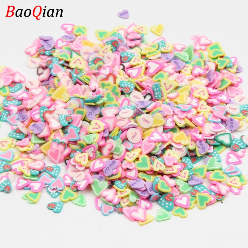 A pile of assorted heart-shaped soft polymer clay slices in various pastel colors for nail art and DIY crafts.