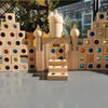 A wooden gemstone building block structure featuring various colored acrylic crystals and natural wood elements.