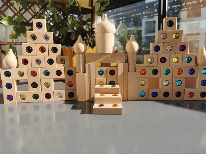 A wooden gemstone building block structure featuring various colored acrylic crystals and natural wood elements.