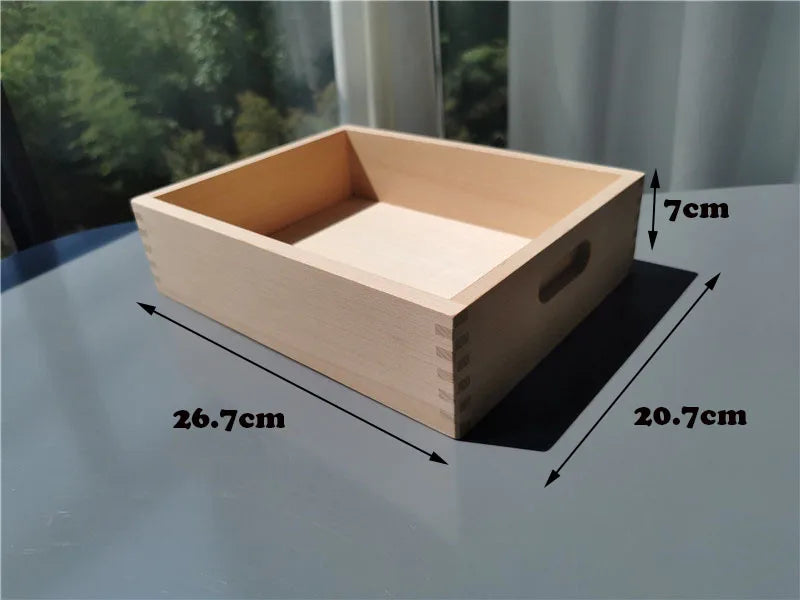 A light wooden box shaped like a rectangular block with an open top, showing its dimensions.