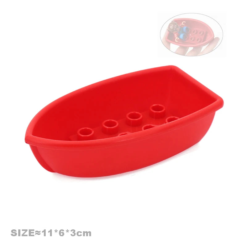 A red plastic building block set featuring vehicles and a trailer.