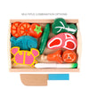 A wooden magnetic fruit and vegetable cutting play set featuring various colorful, shaped pieces.