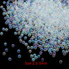 A pile of small, iridescent glass bubble beads in various shades of blue and purple.