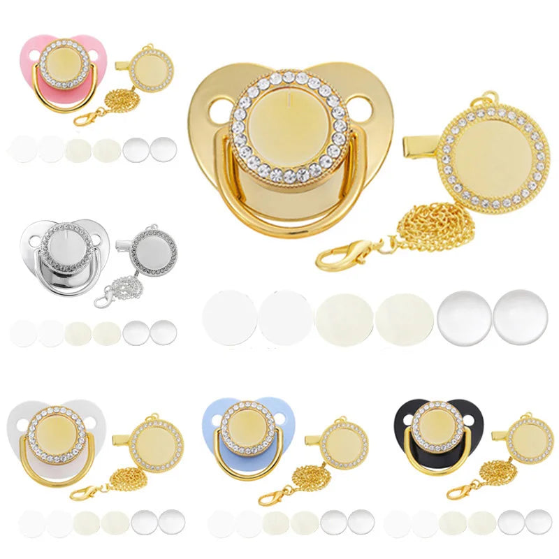 A set of baby pacifiers and clips with rhinestone accents shown in various colors and gold tones.