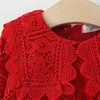 Red lace princess dress for a toddler girl with a doll collar displayed on a wooden hanger.