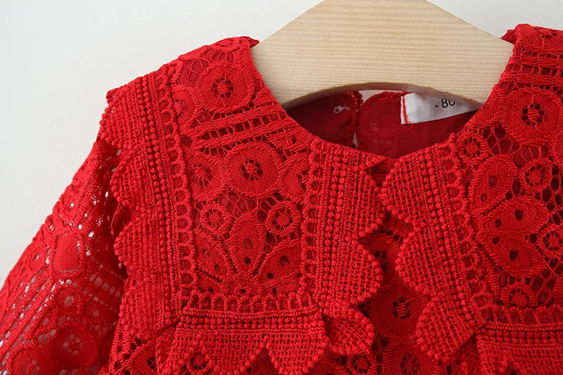 Red lace princess dress for a toddler girl with a doll collar displayed on a wooden hanger.