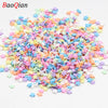 A pile of colorful star-shaped polymer clay slices for nail art and DIY crafts