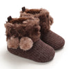 Pair of brown faux fur baby snow boots for girls and boys with anti-slip soles