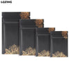 A set of black mini reusable ziplock bags featuring gold leaf decorative patterns.