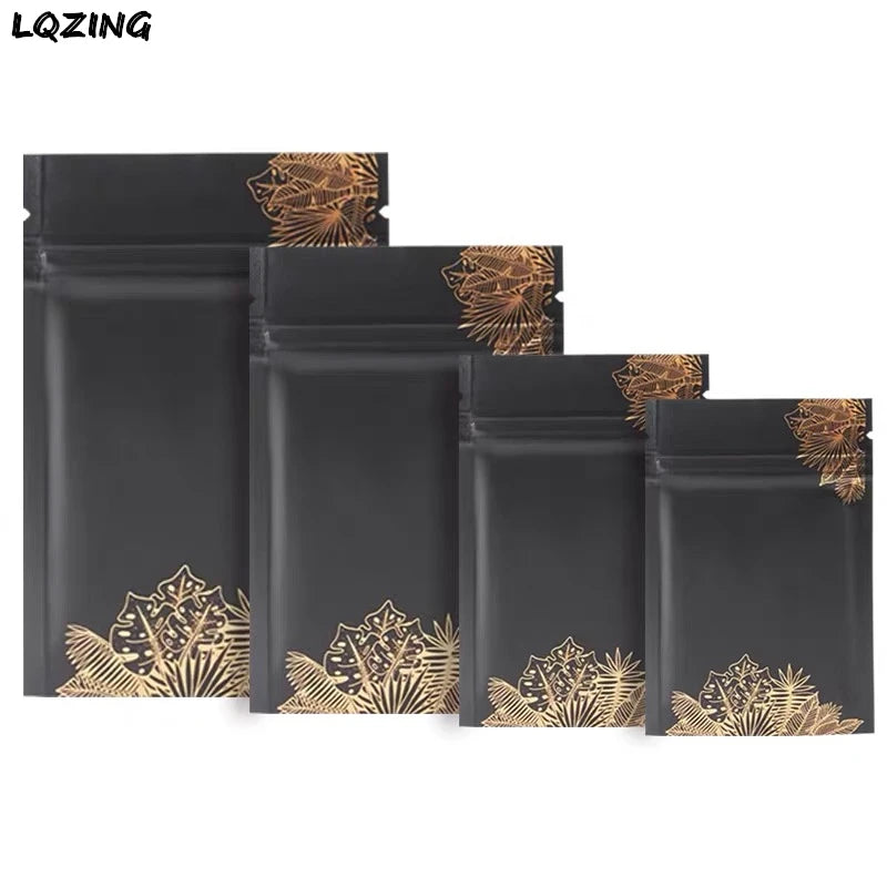 A set of black mini reusable ziplock bags featuring gold leaf decorative patterns.