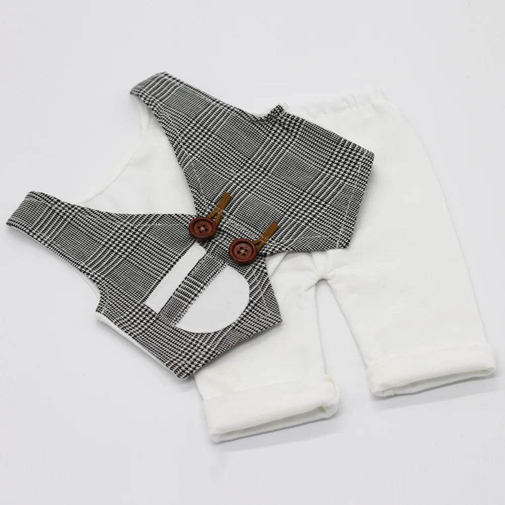A black and white plaid vest and matching white long-sleeved outfit for a newborn photography set.