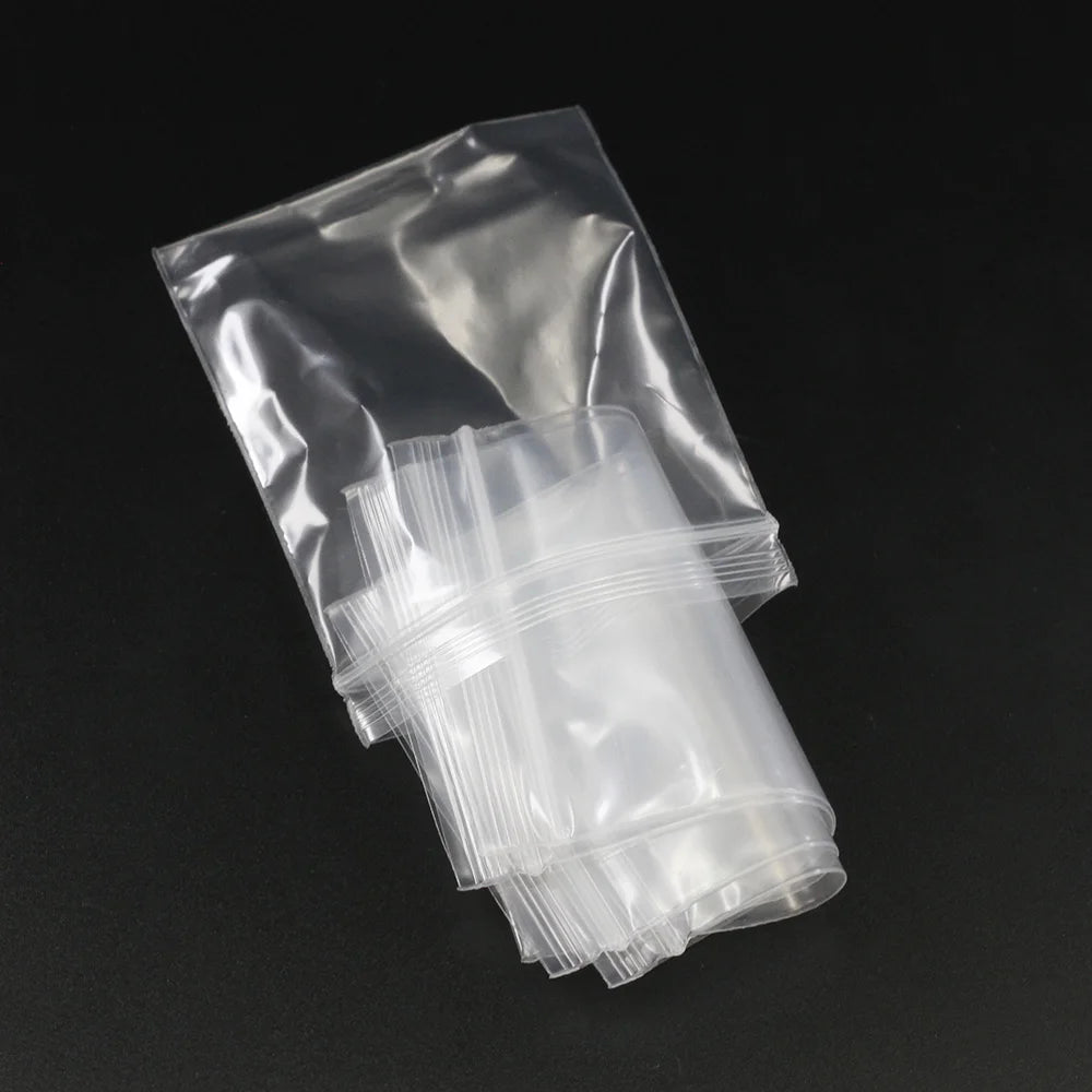 A clear resealable plastic bag filled with multiple small, clear plastic bags for jewelry and item storage.