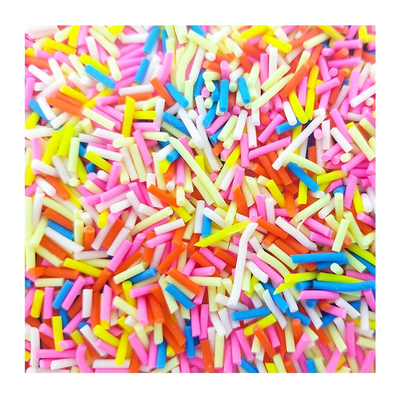 A close-up view of a pile of colorful soft polymer clay candy sprinkles for cake decorating.