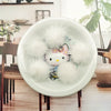 A white ceramic plate holds several fluffy white mink fur pom poms for crafts and accessories.
