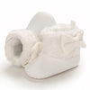 White plush baby snow boots for girls and boys with a fluffy bow detail
