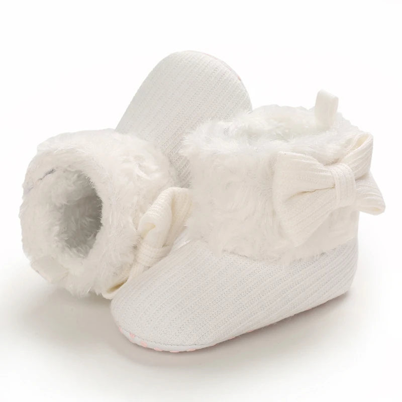 White plush baby snow boots for girls and boys with a fluffy bow detail
