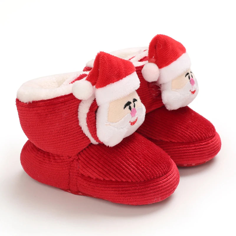 A pair of red Christmas-themed baby first walker shoes with white trim and festive facial features.