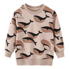 A light pink kids cotton long sleeve pullover sweatshirt featuring a black whale print.