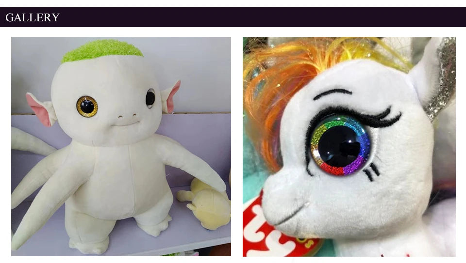 A white plush toy resembling an alien creature with green hair and large eyes.