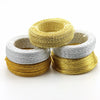 Three spools of flexible aluminum craft wire in gold, silver, and copper tones.