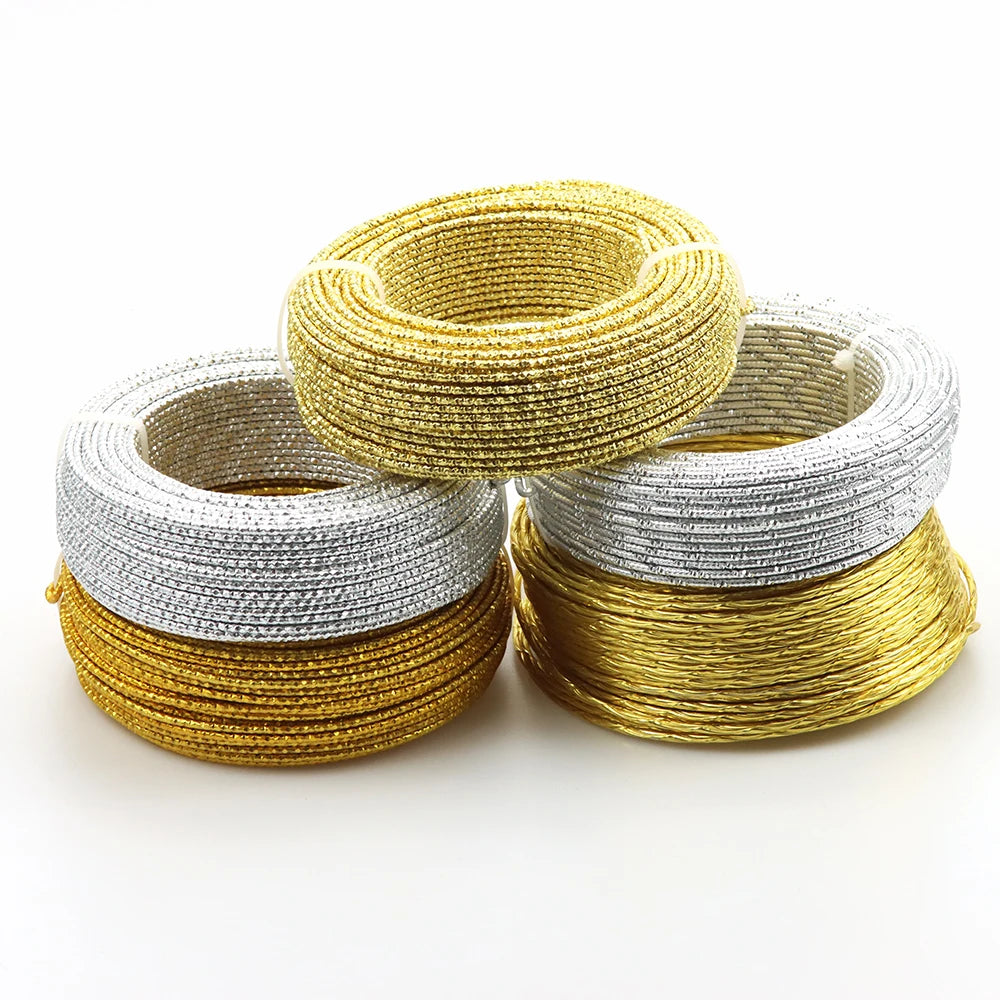 Three spools of flexible aluminum craft wire in gold, silver, and copper tones.