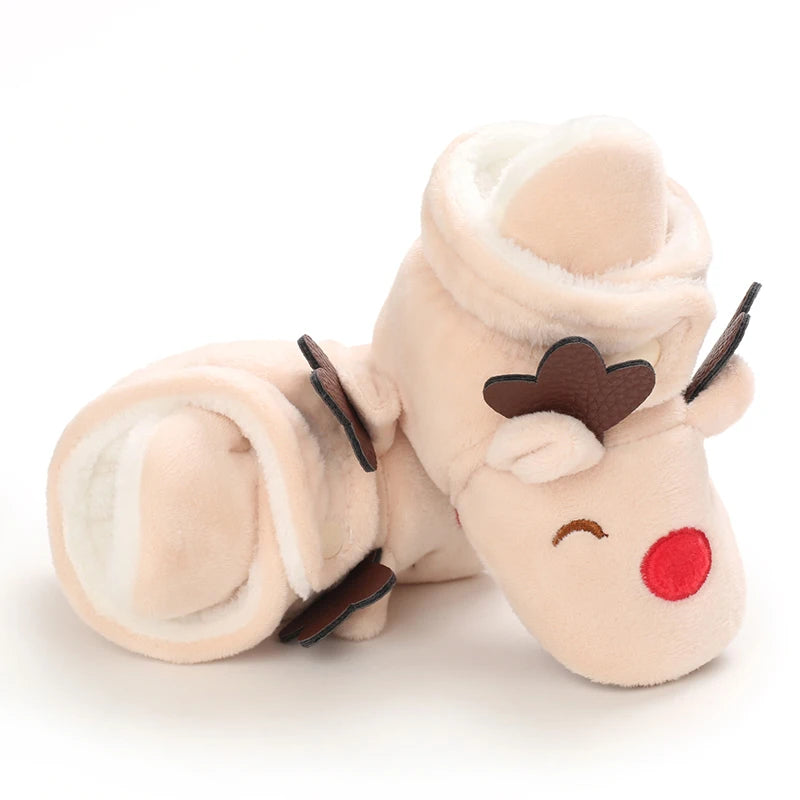 A soft, light beige plush baby first walker shoe shaped like a cute animal with closed eyes and a brown nose.