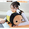 A young woman is holding a Kawaii Bee Ladybug plush toy while working on a laptop.