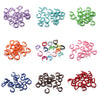 A collection of colorful metal open jump rings in various shades including purple, teal, green, orange, pink, blue, and red.