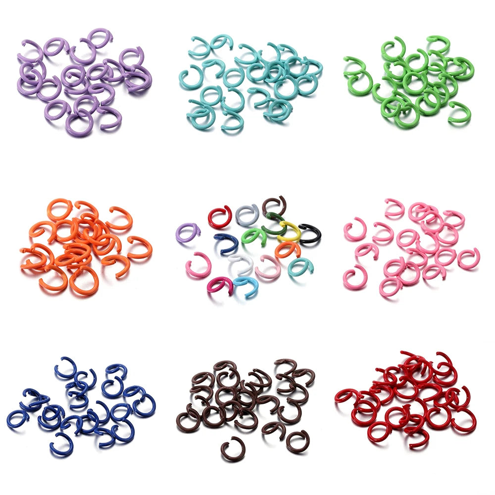 A collection of colorful metal open jump rings in various shades including purple, teal, green, orange, pink, blue, and red.