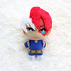 A plush figure of a character with red and white hair, blue eyes, and a blue outfit.
