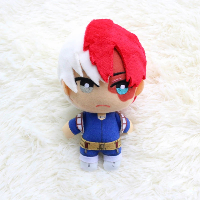 A plush figure of a character with red and white hair, blue eyes, and a blue outfit.