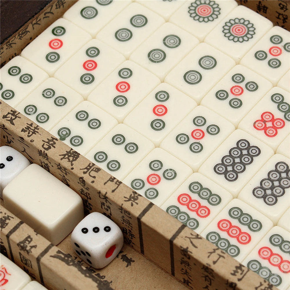 A wooden box contains a set of classic Chinese mahjong tiles with 144 tiles and a carrying case.
