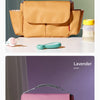 A tan saddle-colored bottle holder and cup organizer shown next to a lavender colored version.