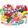 A set of magnetic wooden fruit and vegetable cutting toys in various colors and shapes.