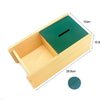 A wooden sensory toy set featuring a light wood box and a dark green lid, shown at an angle with dimensions.