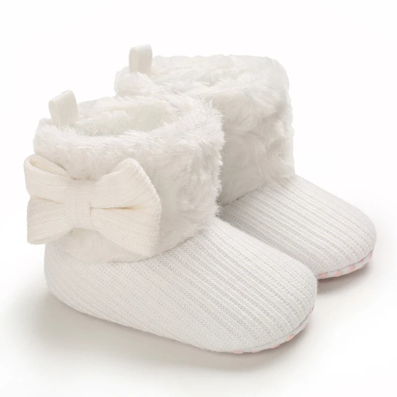 White plush baby snow boots for girls and boys with a bow detail