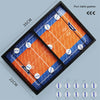 A black tabletop game board with two orange and blue playing fields for a sling puck battle game