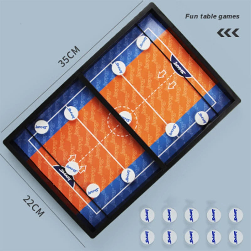 A black tabletop game board with two orange and blue playing fields for a sling puck battle game