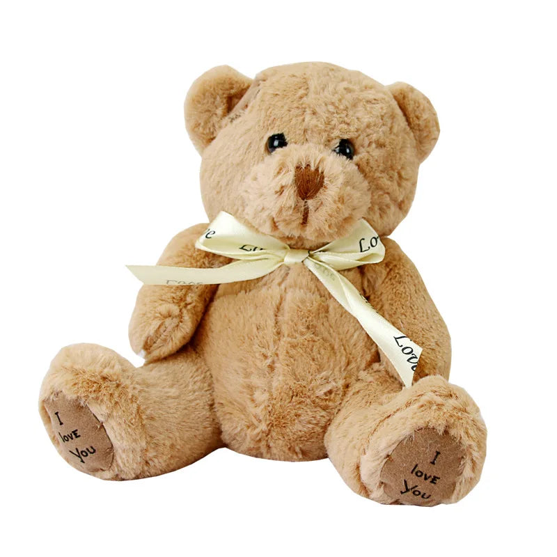 A soft brown teddy bear plush toy with a light yellow ribbon tied around its neck and paws.